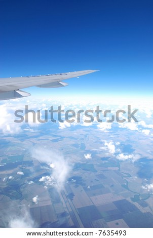 Plane wing against blue sky