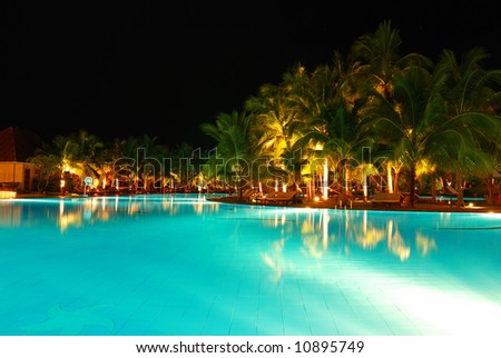 Tropical pool in luxury hotel at night