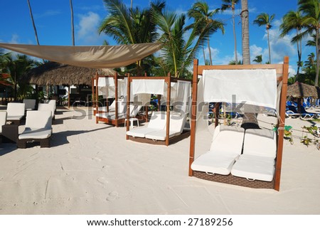 Luxury wooden chaise lounge on beautiful caribbean beach in Dominican Republic