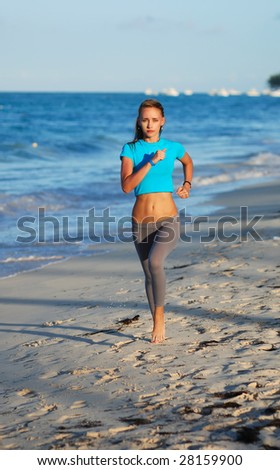 Woman jogging at evening beach