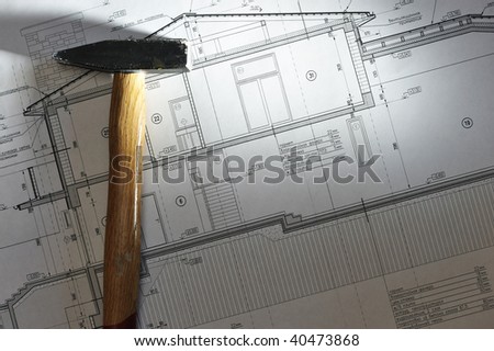 Hammer tool over house plan blue prints