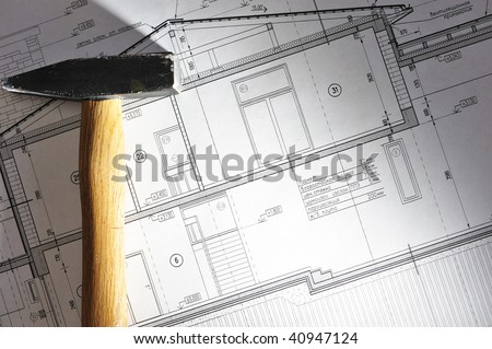 Hammer tool over house plan blue prints