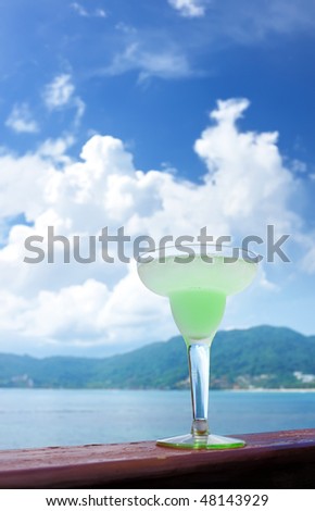 Margarita cocktail with sea and sky in background