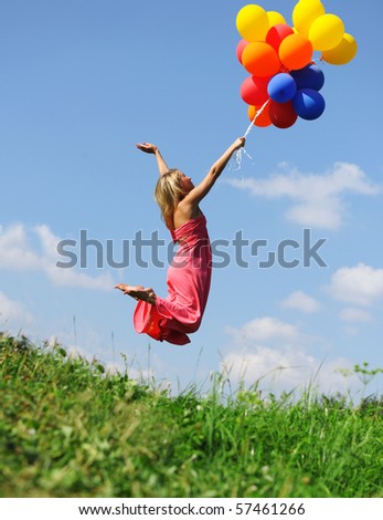 Girl jumping with balloons trying to fly