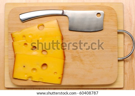 Swiss cheese and knife on board