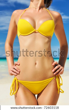 Woman with  beautiful body on a tropical beach