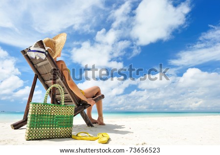 stock photo : Woman on a tropical beach with hat