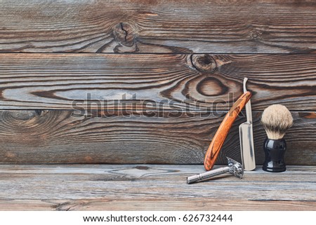 Vintage barber shop tools on old wooden background with copy space
