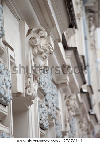 statue of a woman as a support on the building\'s facade