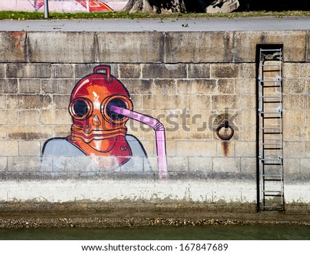 VIENNA, AUSTRIA - OCTOBER 04: Diver with straw  graffiti  on  Danube Canal wall on October 04, 2013  in Vienna, Austria
