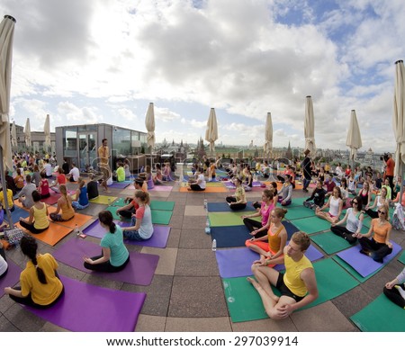 MOSCOW -MAY 31: Surya Namaskar (Sun Salutation) - public yoga classes on the roof of the Ritz-Carlton Hotel, Red Square background on May 31, 2015 in Moscow, Russia