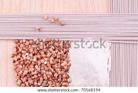 Buckwheat, buckwheat flour, buckwheat noodles on wooden background