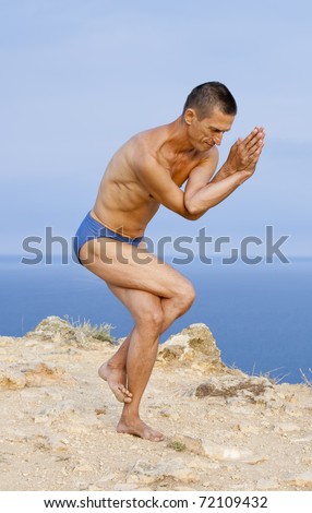 stock photo : Garudasana - "pose of eagle".Yoga exersicing outdoor