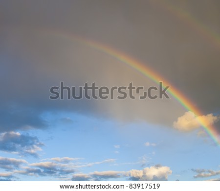 Rainbow in front of dark cloud
