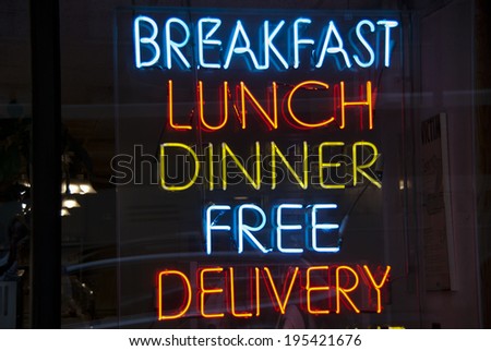 Breakfast, Lunch, Dinner neon sign in a New York City diner