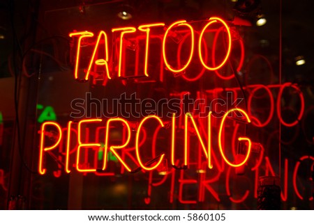Neon sign in the window of a tattoo 