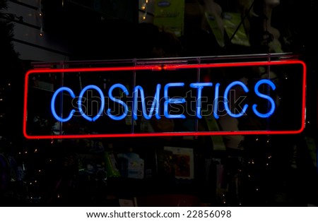 Neon cosmetics sign in the window of a Harlem, New York City store