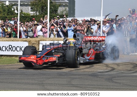 GOODWOOD, UNITED KINGDOM - JULY 1: Formula One drive Lewis Hamilton drives up the hill at the Goodwood Festival of Speed in the United Kingdom on July 1, 2011 in Goodwood, UK