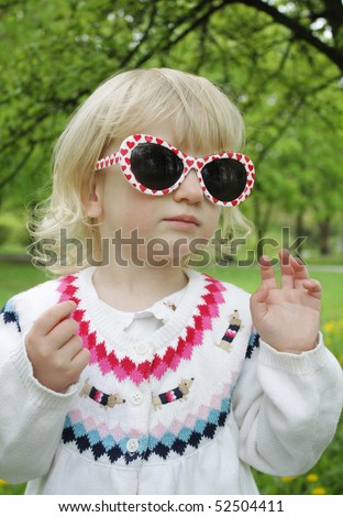 Child in sunglasses on a walk
