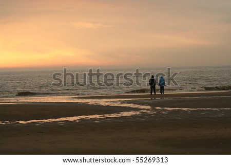 Romantic evening walk on the beach in the sunset, Netherlands