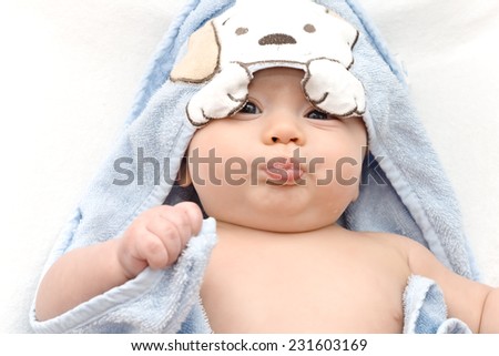 baby wrapped in a towel after a swim