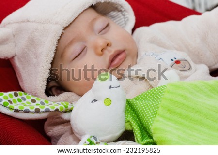 Sweet baby sleeping with stuffed rabbit