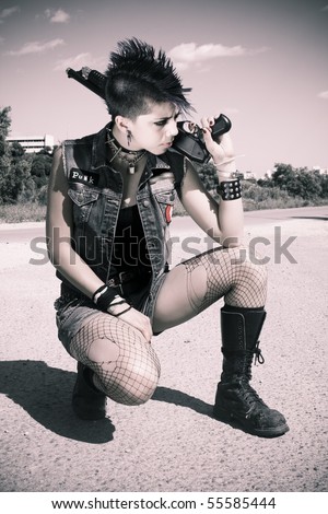 stock photo punk girl kneeling with his gun