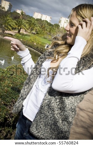 Young woman in the duck pond pointing