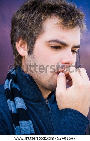 handsome man nail biting shyness