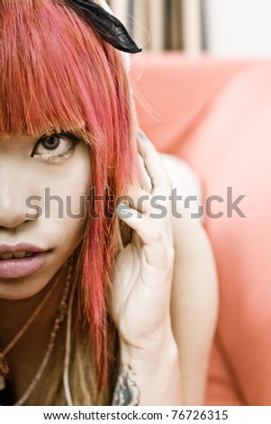 Japanese girl listening to music with headphones