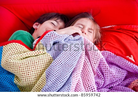 Boy and girl sleeping on the couch