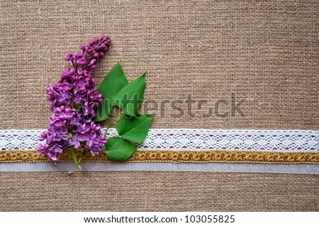 postcard with lilac and handmade ribbons on sacking cloth