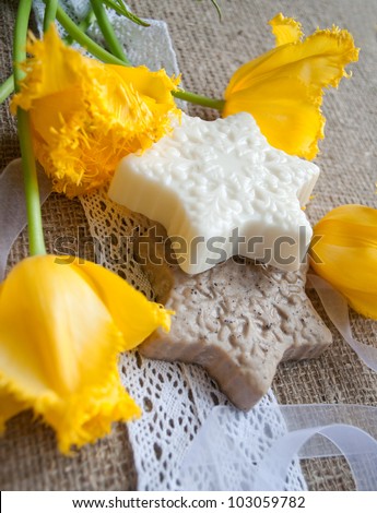 bars of handmade soap with flowers on sacking cloth