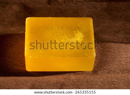 one piece of orange soap on brown paper