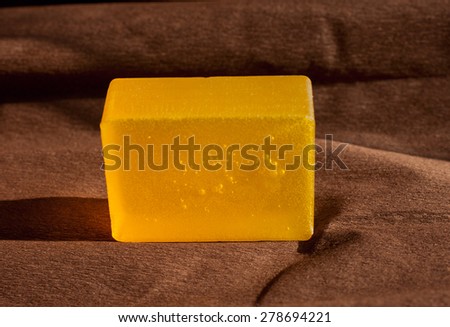 one piece of orange soap on brown paper