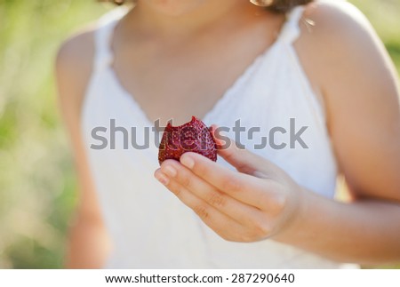 strawberry in hand of girl