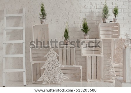 Merry christmas and new year brick wall background. white decor with fir trees and boxes. Loft style