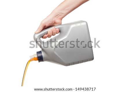 Engine oil pouring from a canister in hand isolated on white background