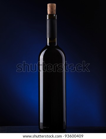 a bottle of wine on a dark background