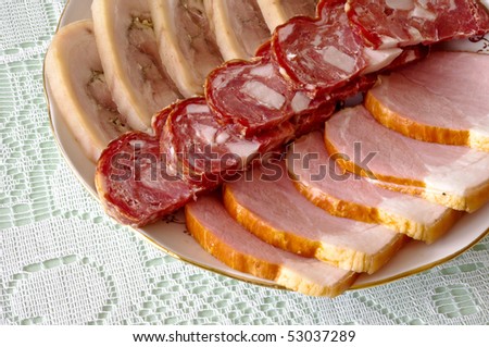 Cutting sausage and cured meat on a celebratory table