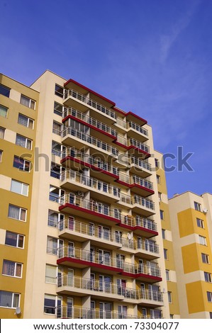 Yellow apartment buildings in a blue sky background in Vilnius, Lithuania