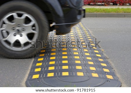 Speed bump on a road when and car