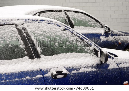 snow-covered cars in town