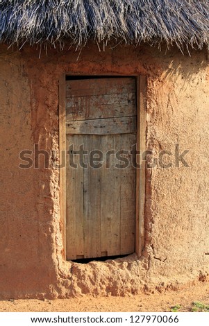 Simple mud hut with a wooden door