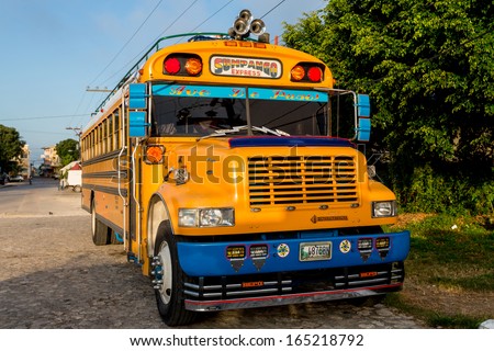 Flores, Guatemala - November 30: A Typical &Quot;Chicken Bus&Quot; Gets Ready To Go Out At Dawn In The Jungle Region Of Northern Guatemala, Guatemala - November 30, 2013