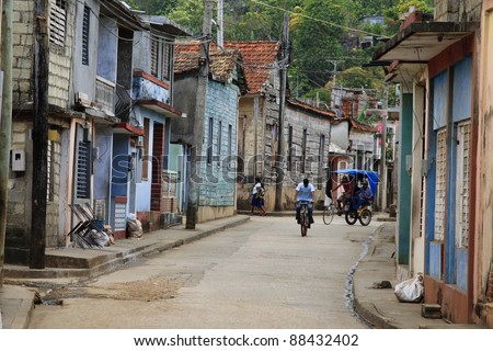 Classic cuban backstreet with bike and rickshaw
