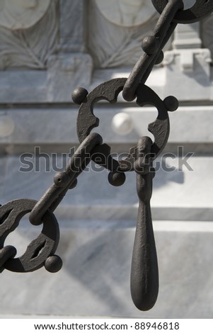 Ornate chain and marble tomb abstract