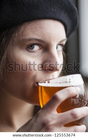 Portrait of a young woman with a glass of India Pale Ale