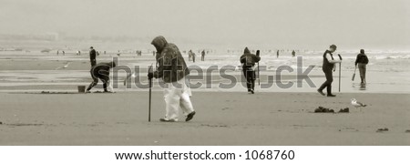 Black and white photo of razor clam diggers braving the elements on the Oregon Coast