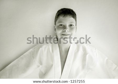 Photo of a boy in his Tae Kwon Do suite isolated against white background